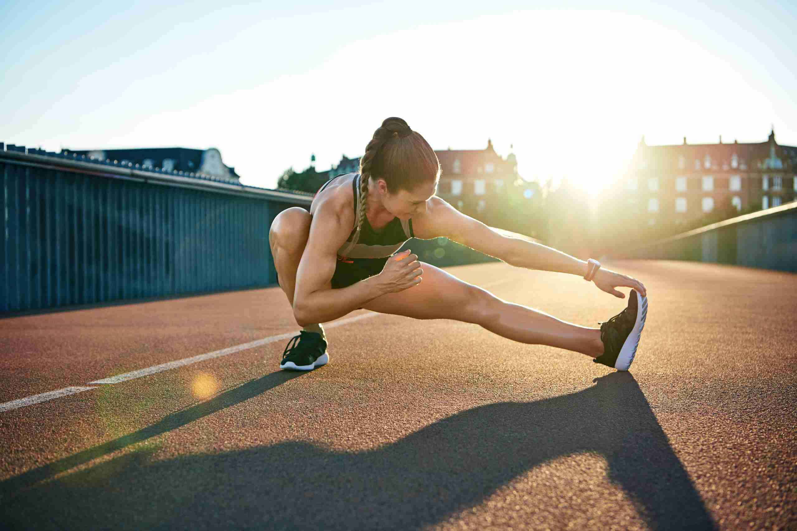 female athlete stretching out during exercise rehabilitation class