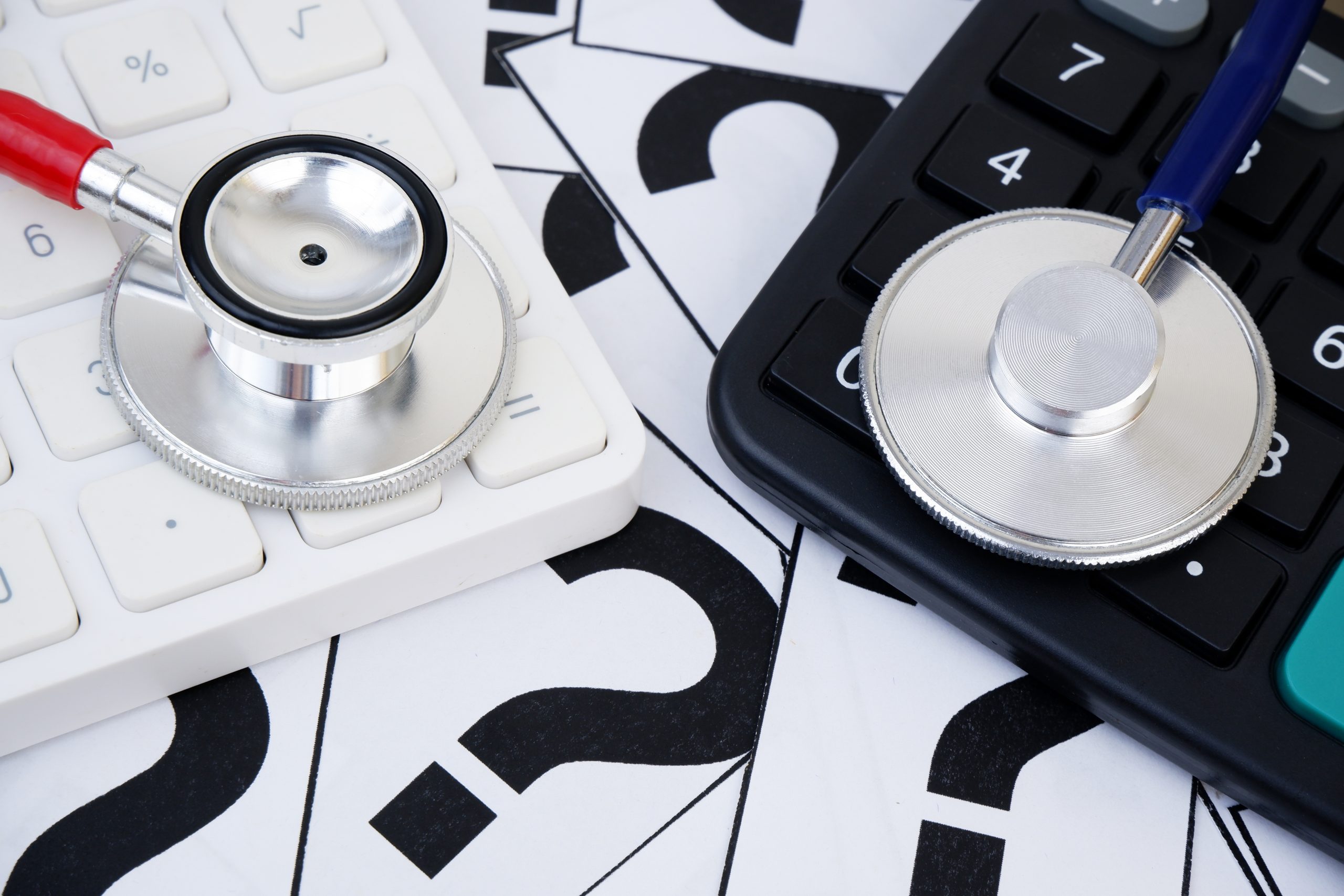 Choosing medical clinic and hospital concept. Cost of medical treatment. Two different stethoscopes on question marks and calculators. Why Insurance Coverage Doesn't Always Match Recovery Needs