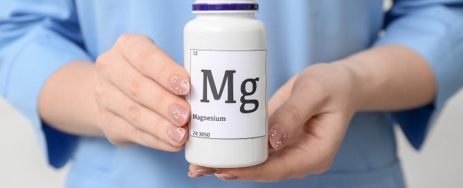 Female doctor holding bottle of magnesium pills, closeup